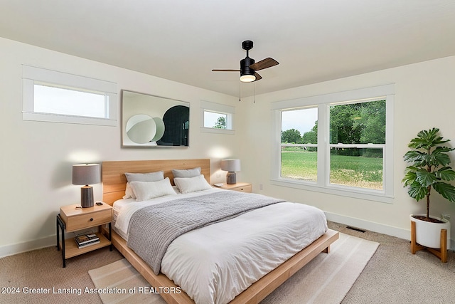 bedroom featuring ceiling fan and carpet