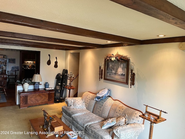 living room featuring carpet floors, beamed ceiling, and a textured ceiling