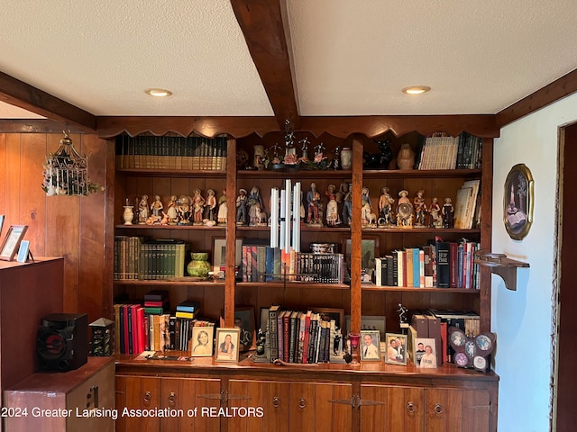 interior details with a textured ceiling and beamed ceiling