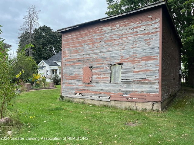 view of side of home with a lawn