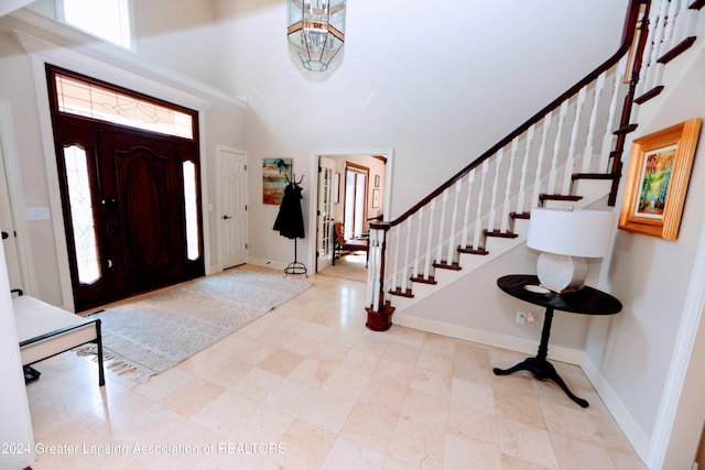 foyer featuring high vaulted ceiling