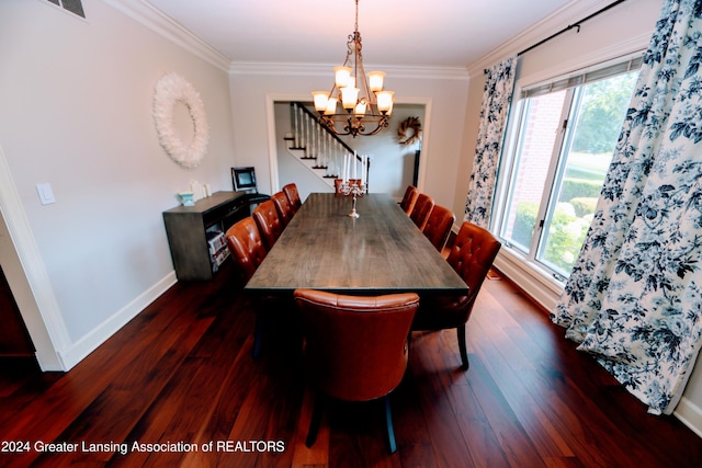 dining space featuring dark hardwood / wood-style flooring, ornamental molding, and an inviting chandelier