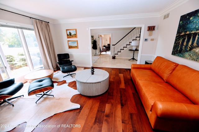 living room with light hardwood / wood-style floors and ornamental molding