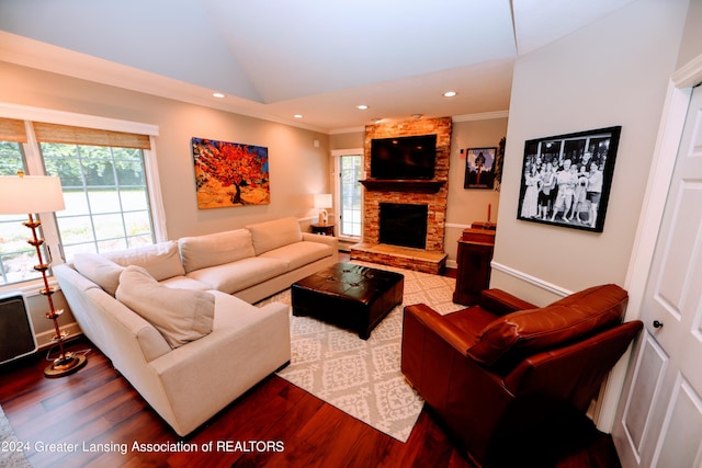 living room featuring a stone fireplace, wood-type flooring, lofted ceiling, and ornamental molding