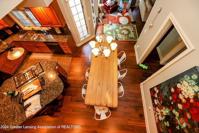 interior space featuring a chandelier, sink, and dark wood-type flooring