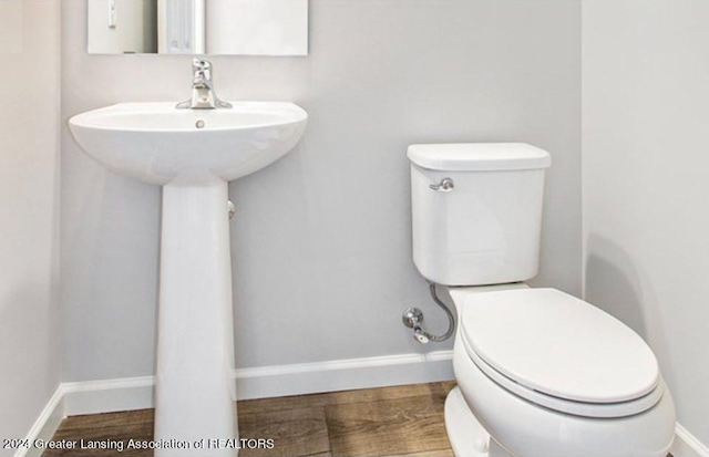 bathroom featuring hardwood / wood-style floors and toilet