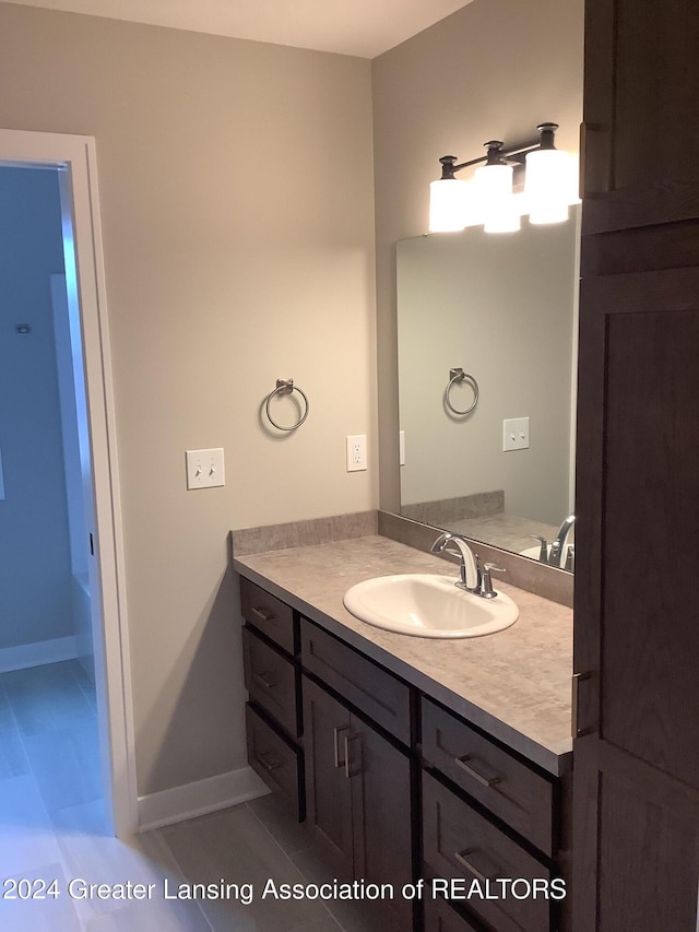 bathroom with tile patterned flooring and vanity