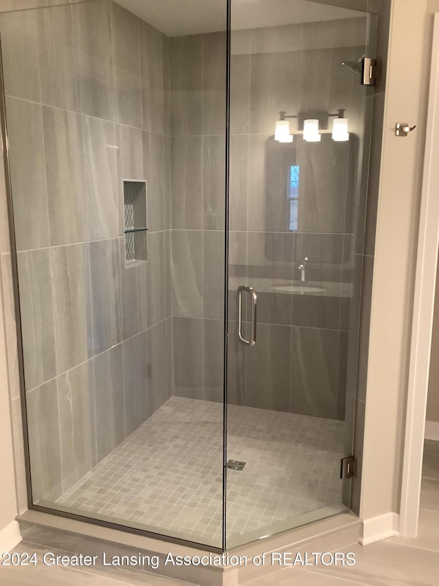 bathroom with a shower with shower door