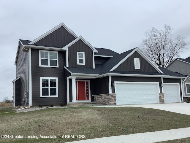 view of front of house featuring a garage and a front lawn