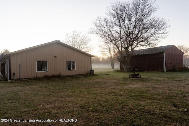 view of property exterior featuring an outbuilding and a yard