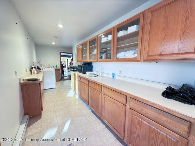 kitchen featuring washer / clothes dryer and a baseboard heating unit