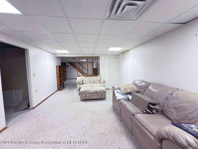 unfurnished living room featuring carpet flooring and a drop ceiling