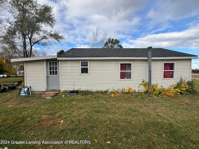 rear view of house with a lawn