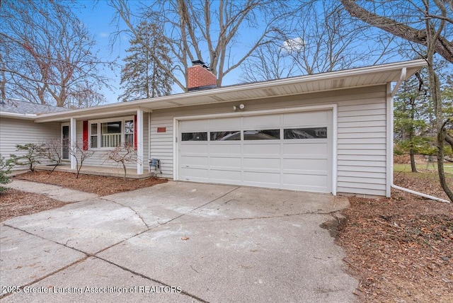 ranch-style home featuring driveway, a chimney, and an attached garage