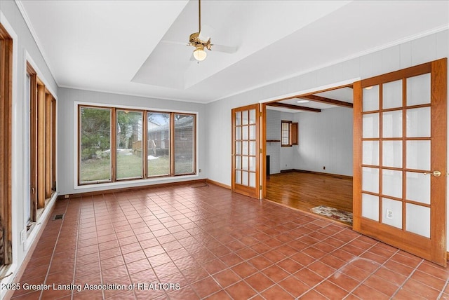 spare room with crown molding, french doors, ceiling fan, and tile patterned floors