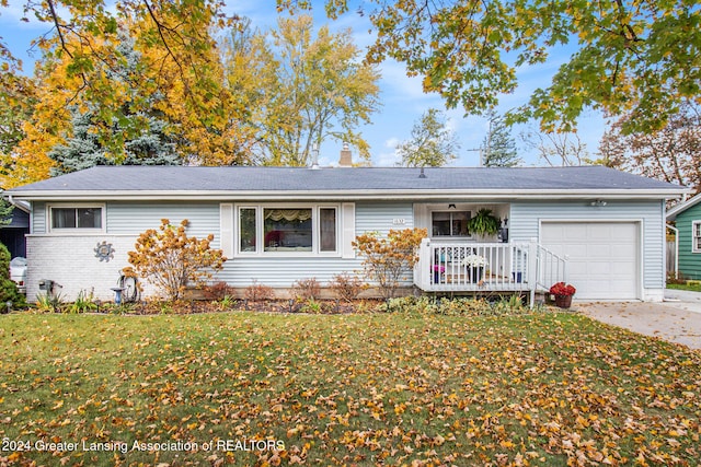 ranch-style home with a porch, a front lawn, and a garage