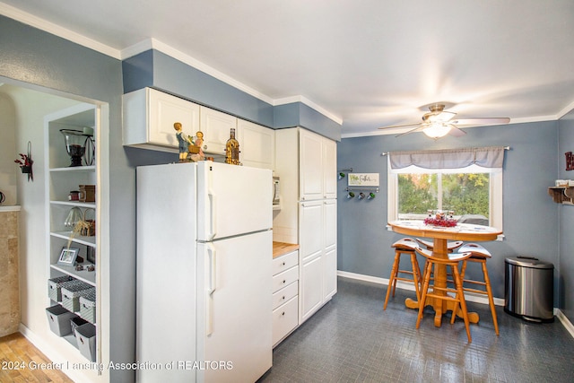 kitchen featuring ornamental molding, white cabinets, ceiling fan, and white refrigerator