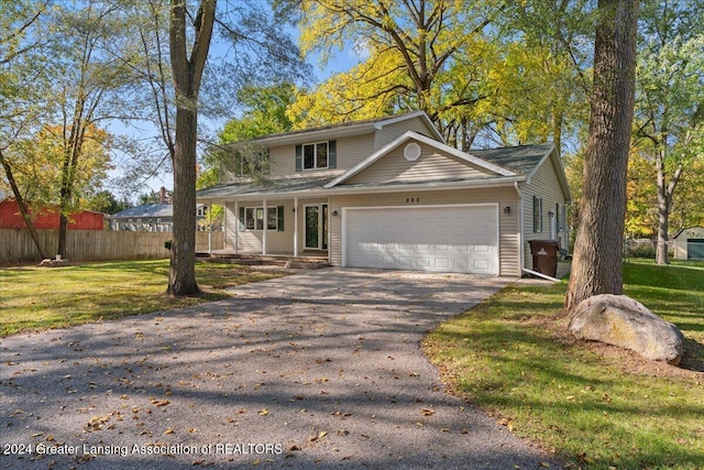 front of property with a front lawn and a garage