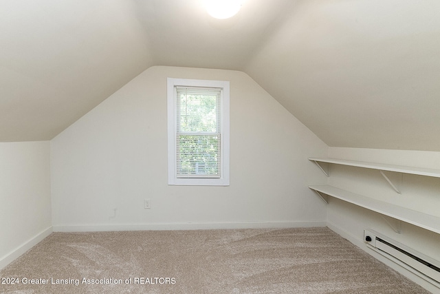 additional living space featuring lofted ceiling, carpet flooring, and a baseboard radiator