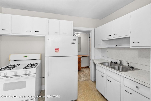 kitchen featuring white cabinetry, sink, and white appliances