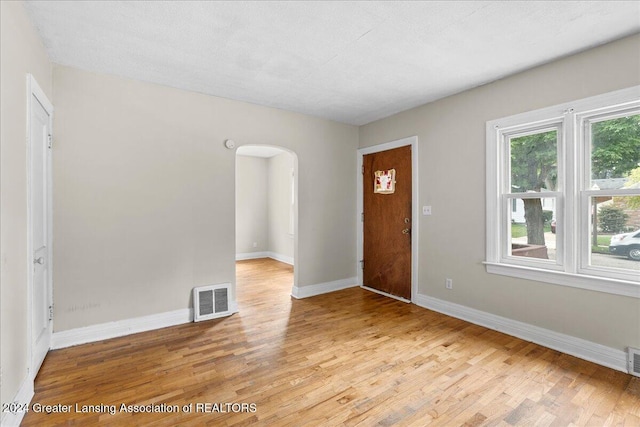 entrance foyer featuring a textured ceiling and light hardwood / wood-style floors