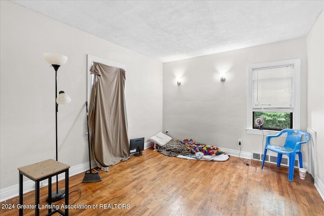 misc room featuring hardwood / wood-style flooring and a textured ceiling