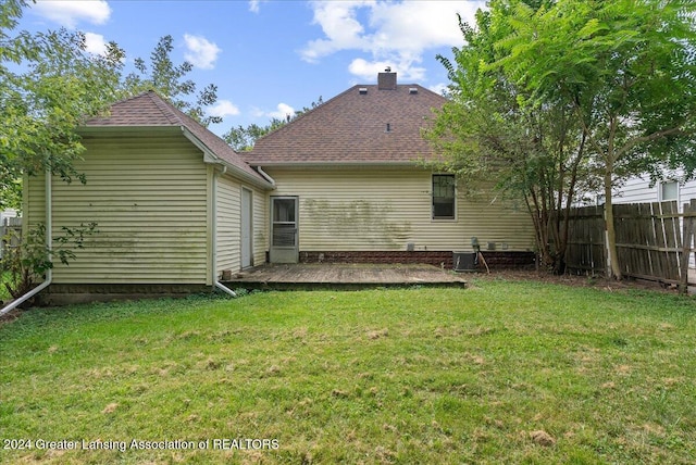 back of house with a lawn