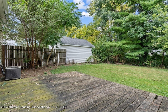 wooden deck featuring central AC and a lawn