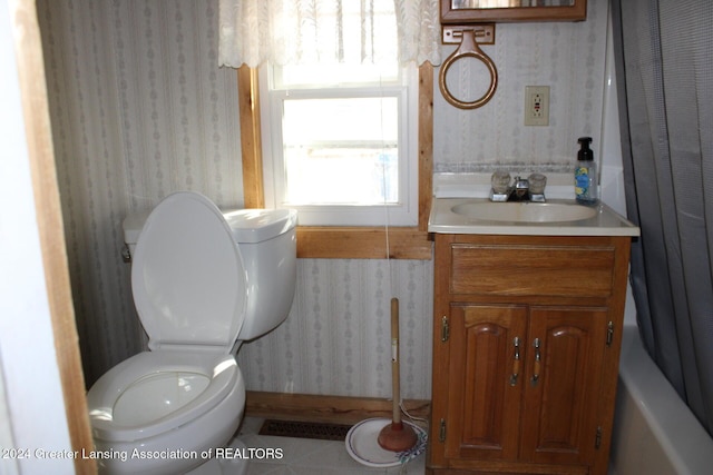 bathroom with vanity, toilet, tile patterned flooring, and wallpapered walls