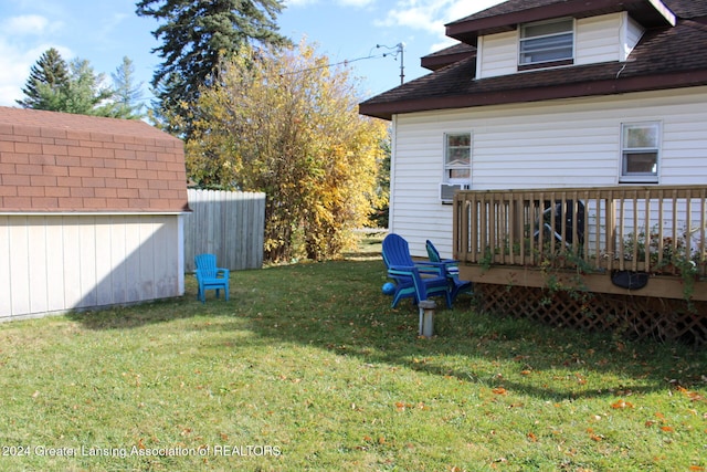 view of yard featuring a storage shed and a wooden deck