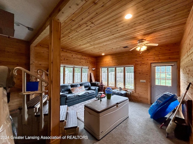 living room with wood ceiling, a wealth of natural light, and ceiling fan