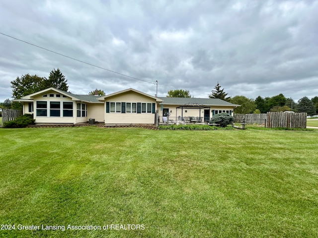 rear view of property with a lawn