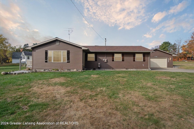 ranch-style house featuring a front lawn and a garage