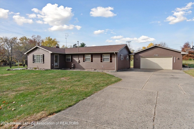 ranch-style house featuring an outdoor structure, a garage, and a front lawn