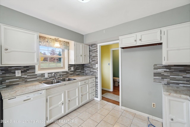 kitchen featuring sink, dishwasher, white cabinetry, and decorative backsplash