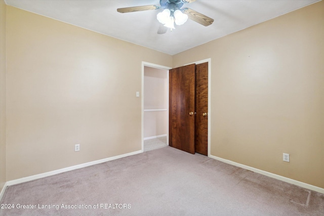 unfurnished room featuring light colored carpet and ceiling fan