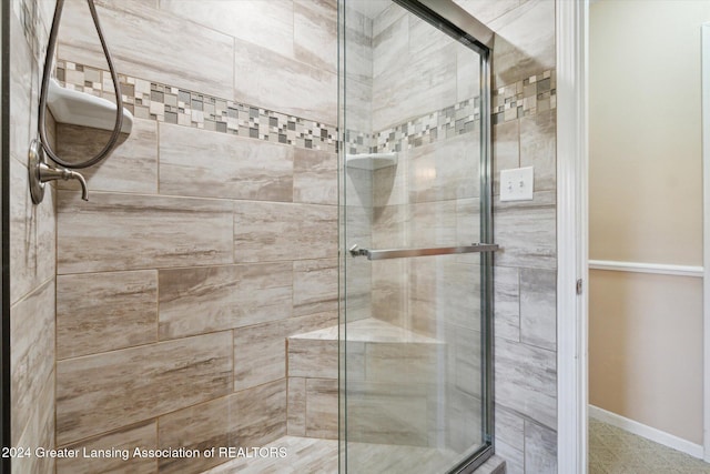 bathroom with a shower with door