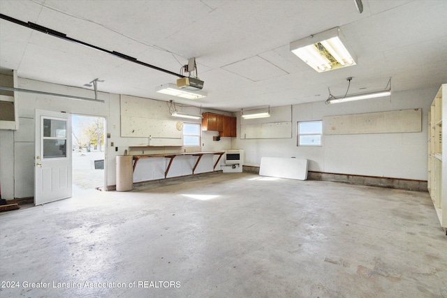 garage with a garage door opener and heating unit