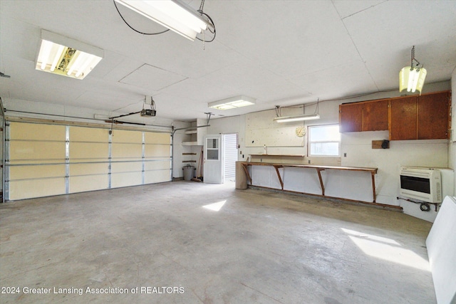 garage with a garage door opener and heating unit