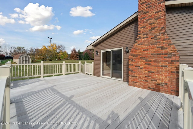 wooden deck with a storage shed