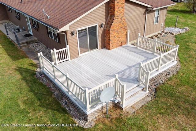 wooden terrace with a lawn