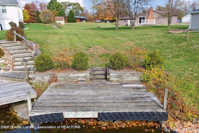 view of yard featuring a deck with water view