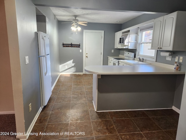 kitchen with kitchen peninsula, sink, white cabinetry, white appliances, and ceiling fan