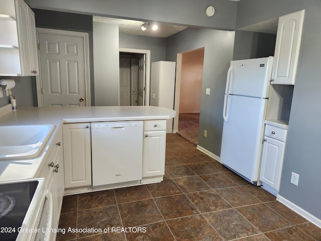 kitchen with white appliances, white cabinetry, sink, and kitchen peninsula