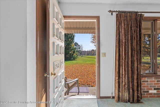 entryway featuring beam ceiling and carpet flooring