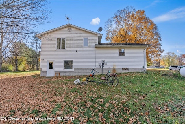 back of property with a lawn