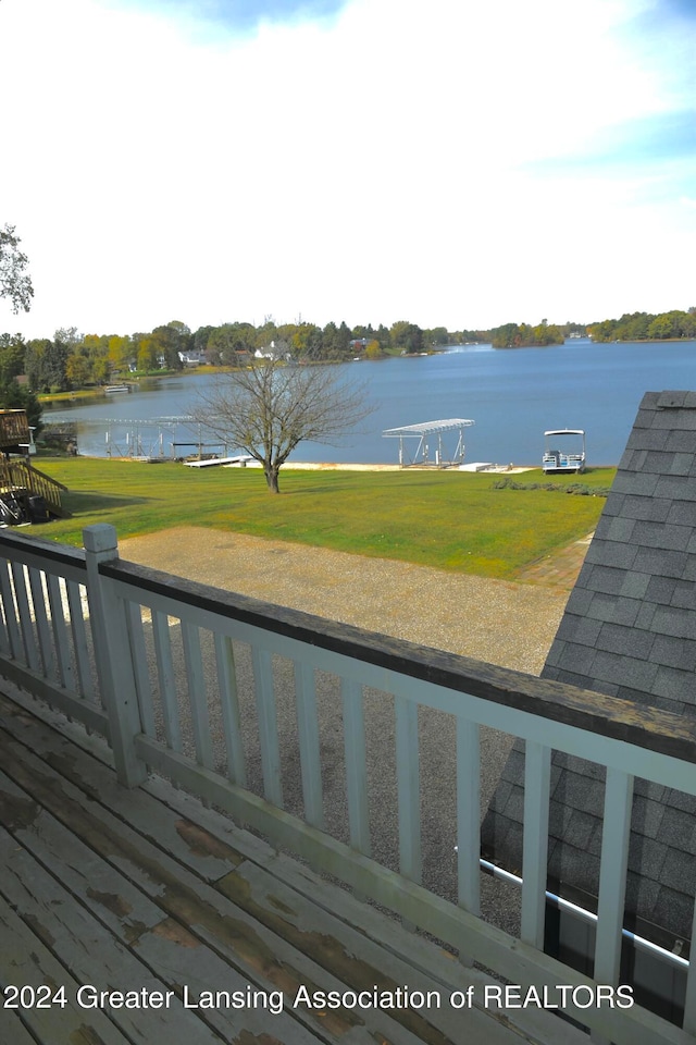 deck featuring a yard and a water view