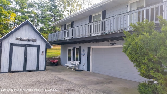 exterior space featuring a balcony and a shed