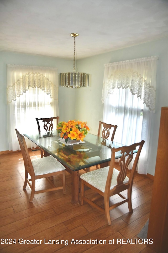 dining room with a notable chandelier and hardwood / wood-style flooring