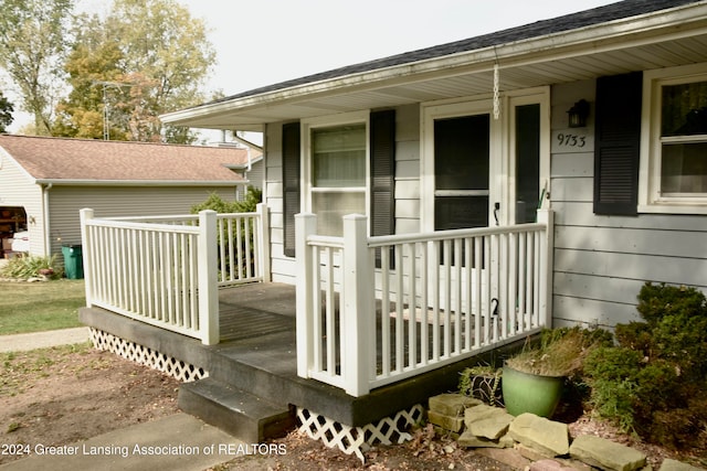 view of exterior entry with a porch